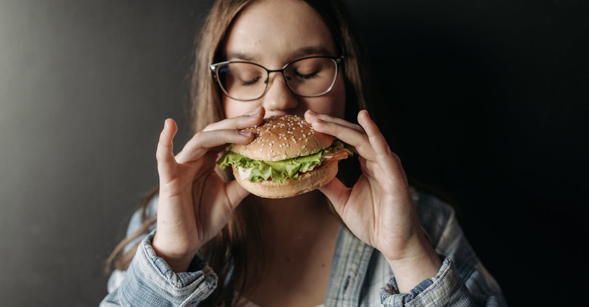 Woman Biting a Hamburger