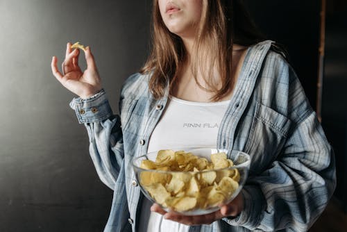 Free A Person Carrying a Bowl of Potato Chips  Stock Photo