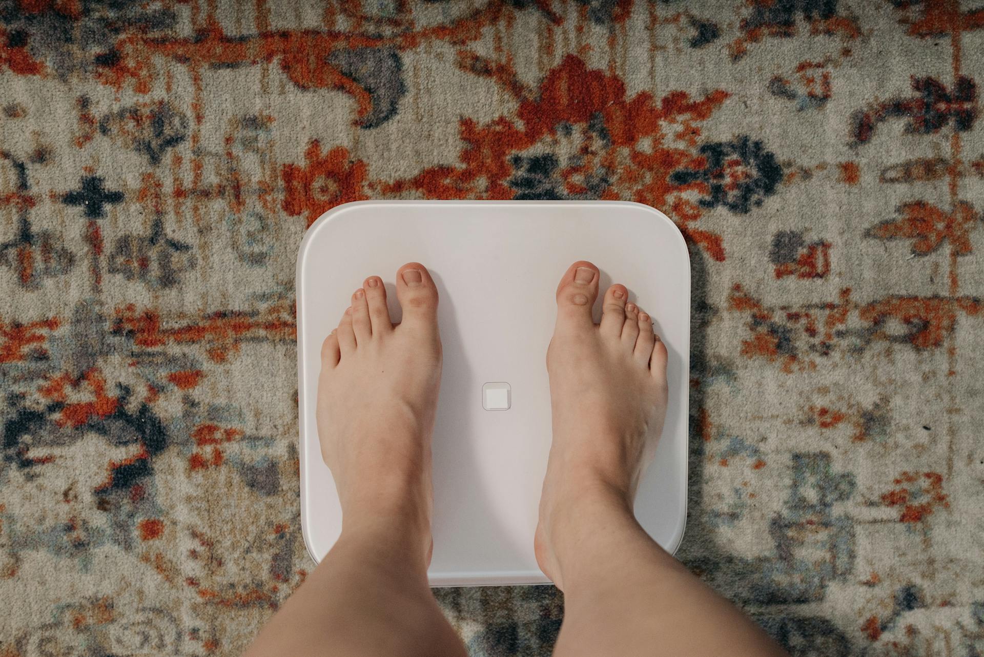 A Person Standing on a Weighing Scale