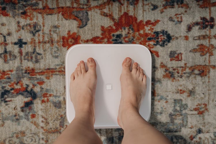 A Person Standing On A Weighing Scale