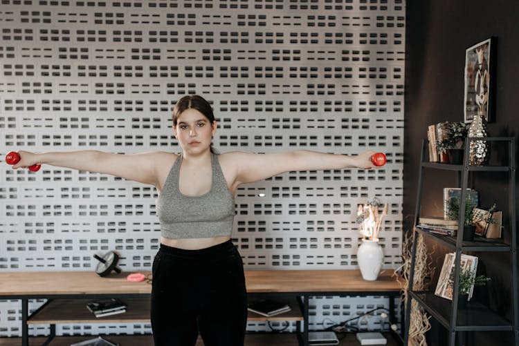 Woman Holding Dumbbell Arms Wide Open