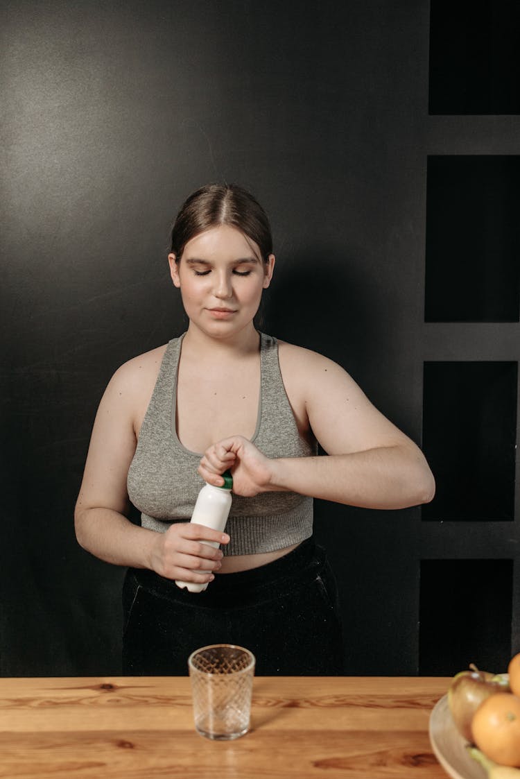 Woman Opening A Bottle