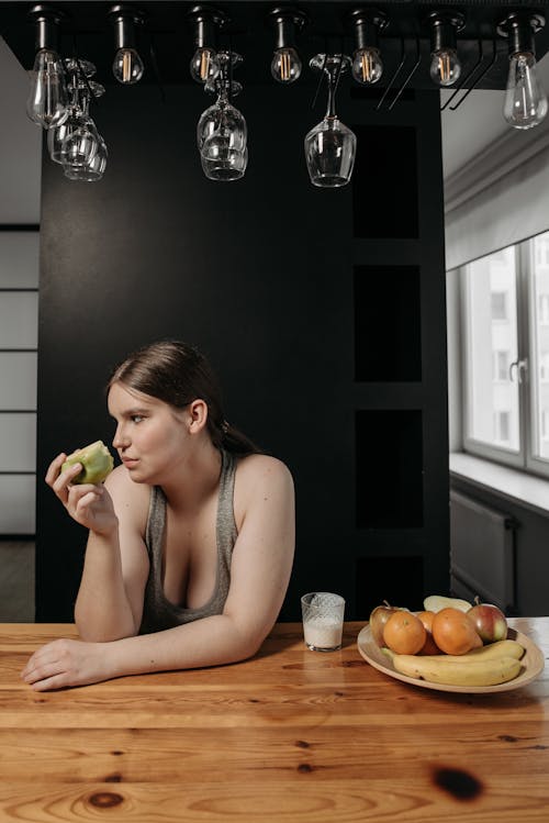 Free Woman Eating a Green Apple Fruit Stock Photo