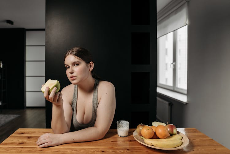 Woman In Gray Tank Top Holding An Apple 