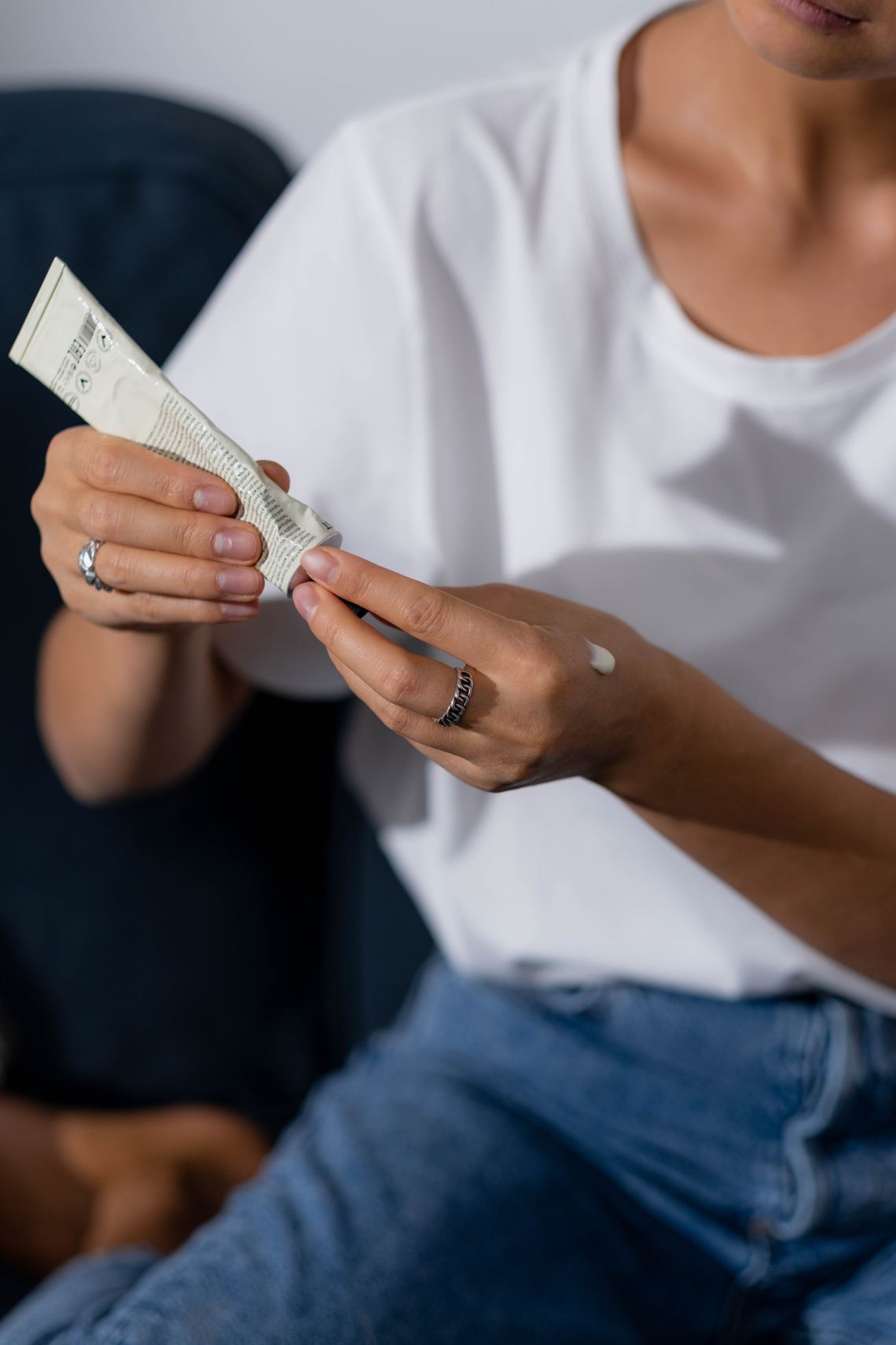 Woman applying hand lotion as part of a skincare routine