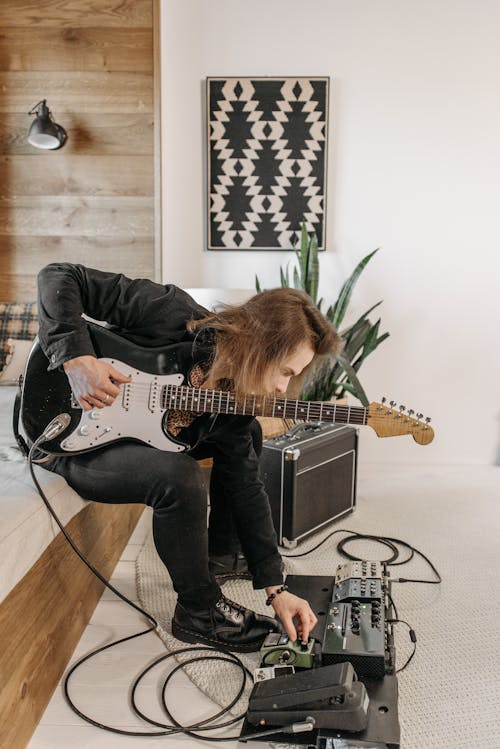 Free Man in Black Jacket Playing an Electric Guitar Stock Photo