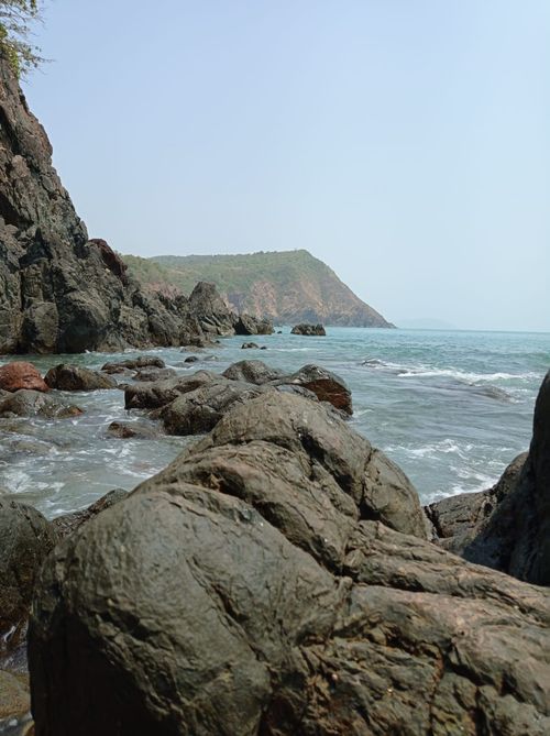 Free Explore the rugged coastline of India with rocky formations leading to a distant peninsula. Stock Photo