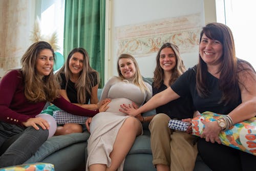 Free Women Holding Baby Bump of their Friend Stock Photo