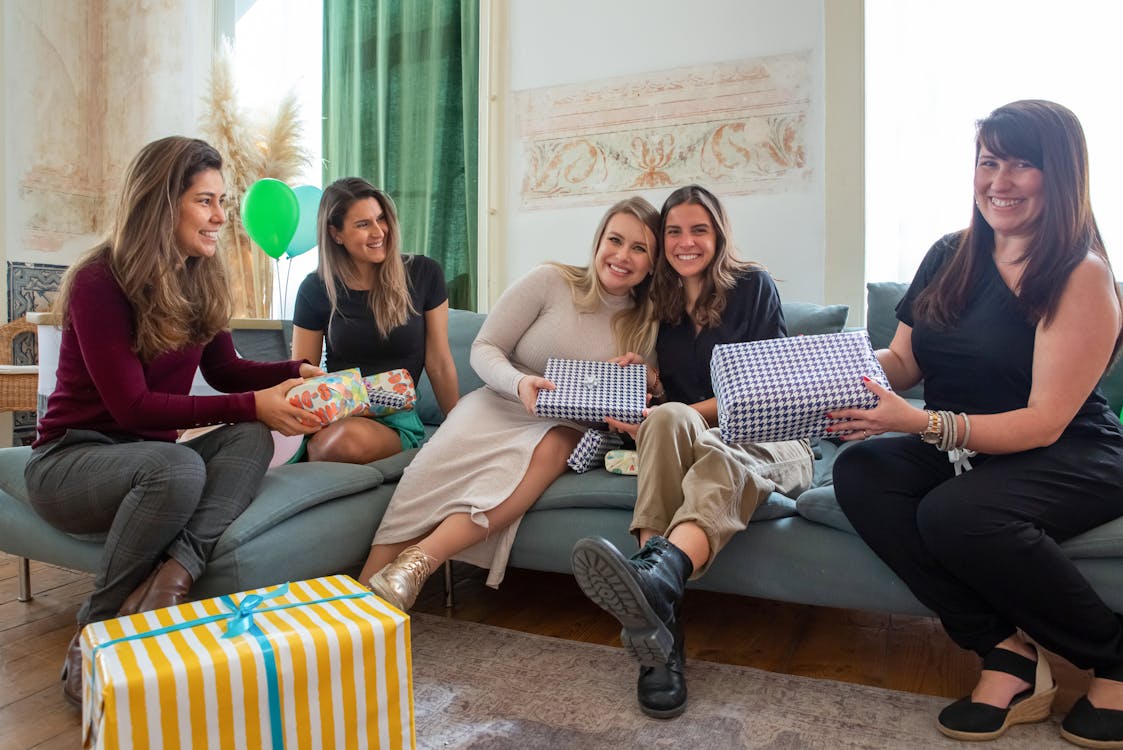 Women with Presents Sitting on a Couch