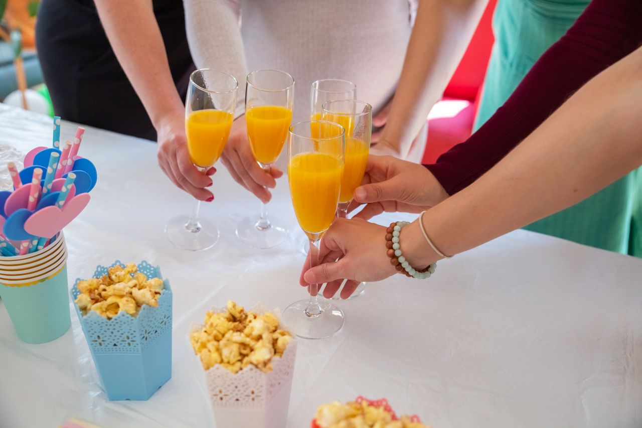 friends toasting with orange juice glasses capturing a fun and vibrant