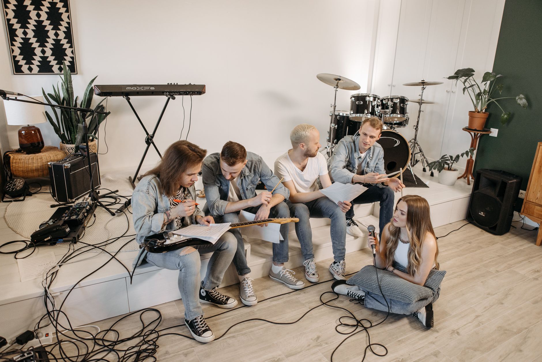 A vibrant and modern studio where young musicians practice together, embodying cultural events featured in the UAEThrive Daily News Roundup.