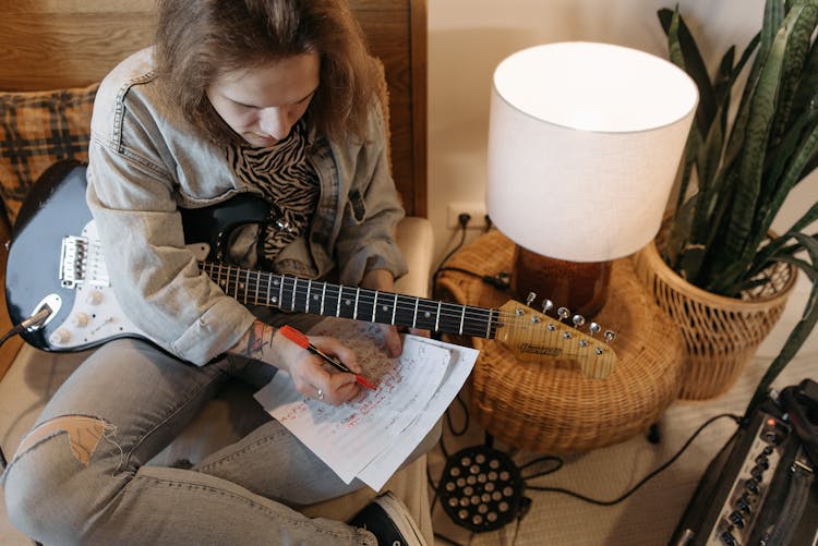 Man Writing On Sheet Music