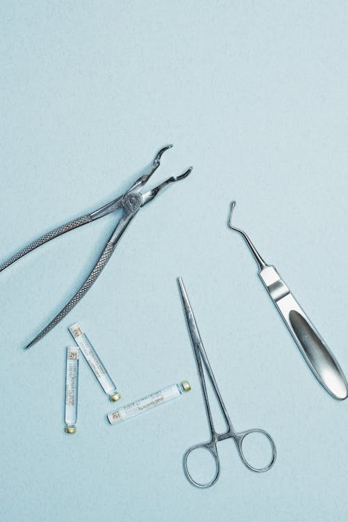 Dental Tools and Vials on a Blue Background