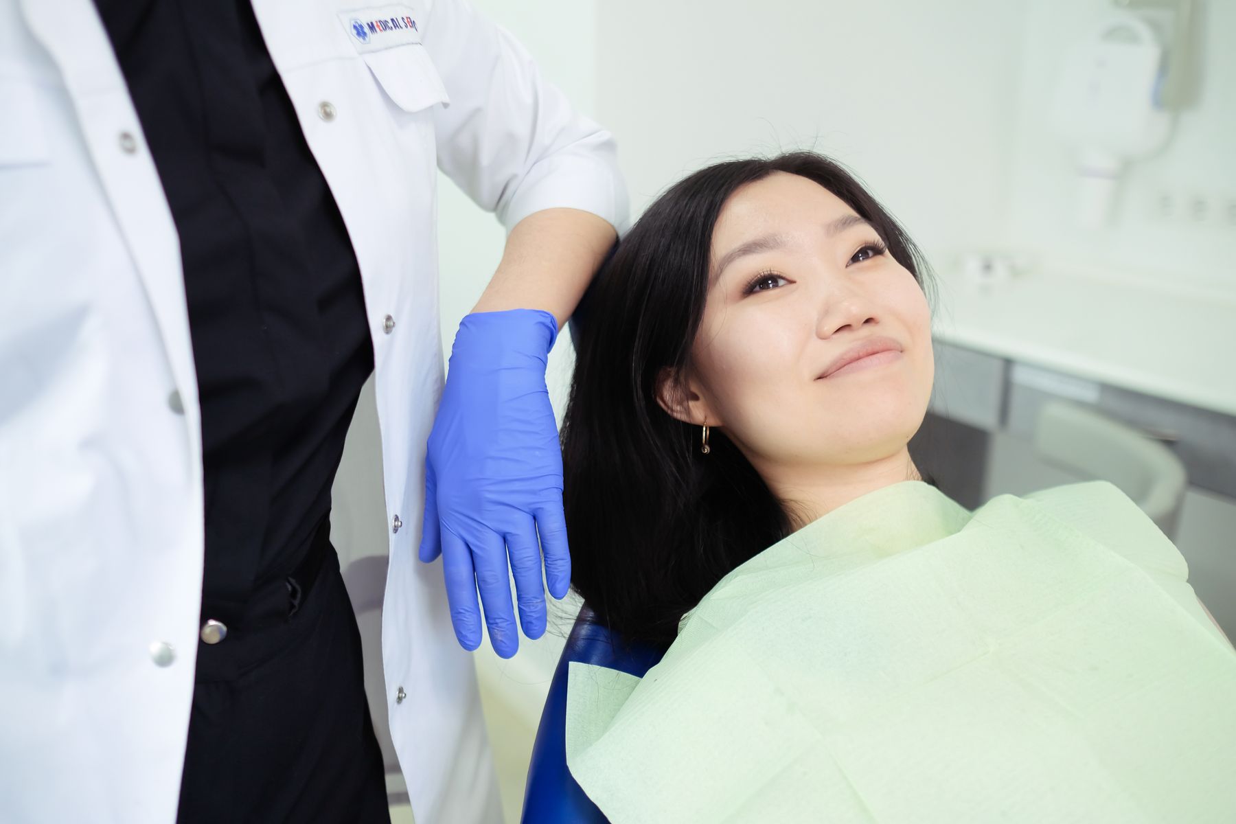 Smiling dental patient and clinician in a bright modern private dental clinic