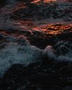 Stormy foamy sea waves at sunset