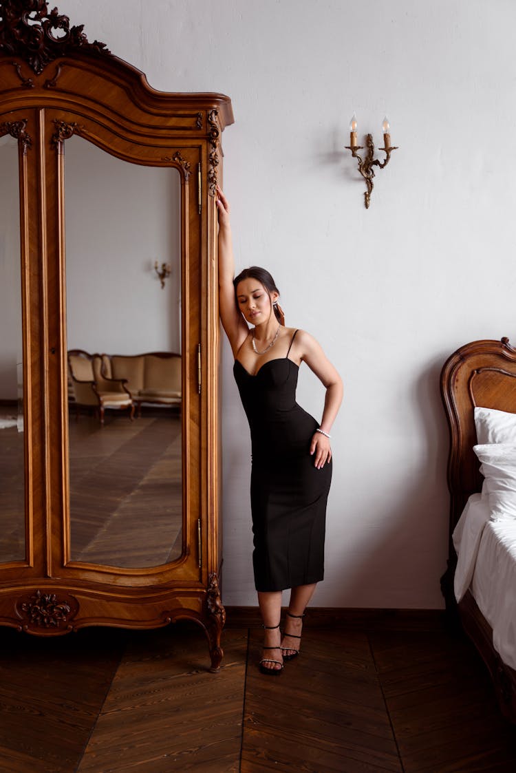 Elegant Woman Near Antique Wooden Wardrobe