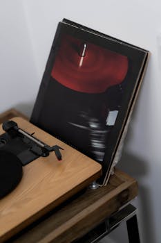 Close-up of a vintage turntable and vinyl records in an indoor setting.