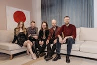 Group of People Sitting on the Sofa