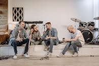 Men Talking while Sitting on an Indoor Stage