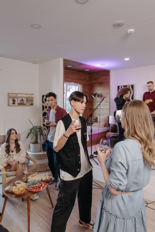 Free Casual indoor gathering with friends enjoying snacks and conversation. Stock Photo