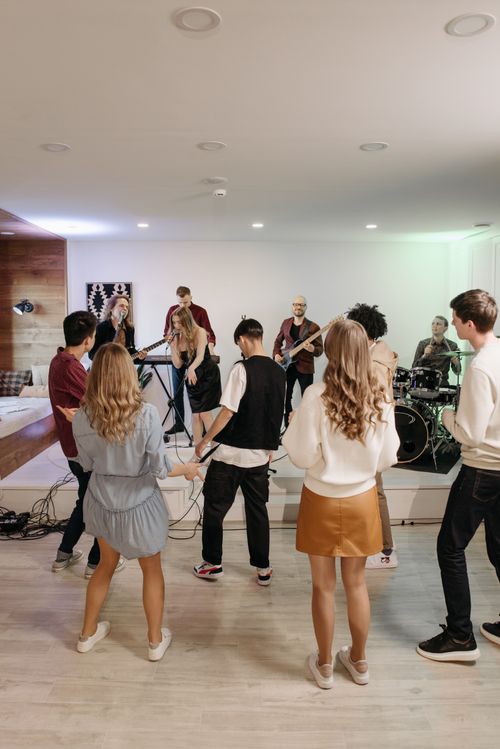 Free A lively indoor party featuring a diverse group dancing to live band music. Stock Photo