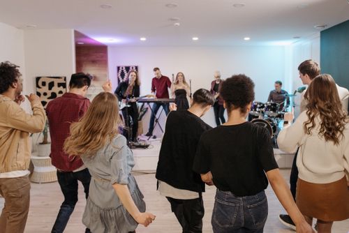 Free A vibrant indoor concert with an energetic crowd dancing to live music. Stock Photo