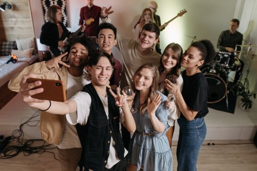 Free A group of diverse friends enjoying a party, captured in a joyful selfie moment. Stock Photo