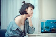 Young Woman Looking at an Aquarium