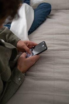 Close-up of a person texting indoors on a smartphone, capturing a moment of modern communication.