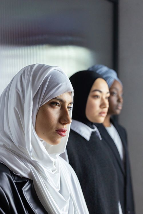 Free Three women in hijabs displaying cultural diversity and unity indoors. Stock Photo