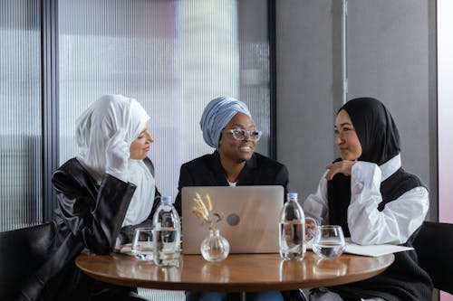 Free Women Sitting In Front of a Table Stock Photo