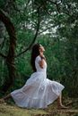 Photo of a Woman in White Dress