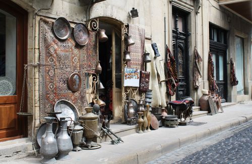 Free Explore an antique bazaar with traditional pottery and carpets in Baku's historic streets. Stock Photo