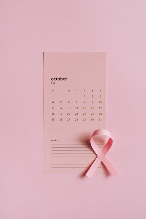 Close-Up Shot of a Pink Ribbon on a Calendar