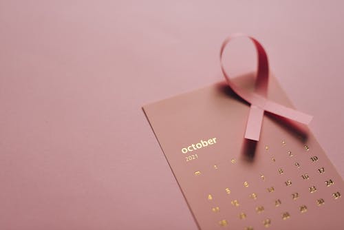 Close-Up Shot of a Pink Ribbon on a Calendar