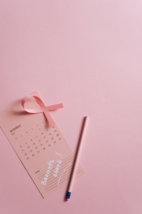 Close-Up Shot of a Pink Ribbon on a Calendar