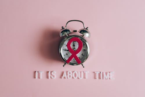 Free A Red Ribbon on an Alarm Clock Stock Photo
