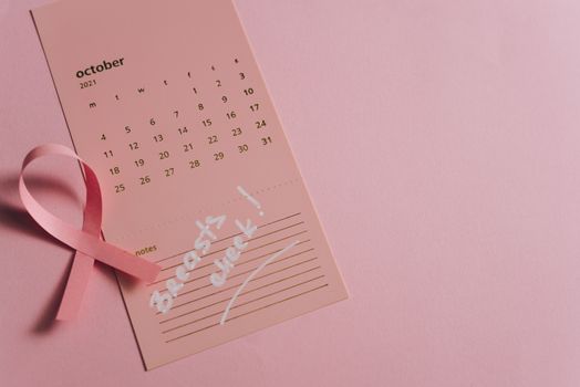 Close-Up Shot of a Pink Ribbon on a Calendar