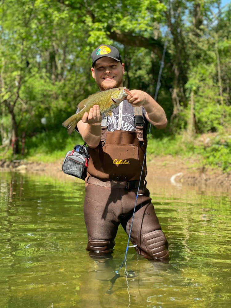 A Happy Fisherman Holding His Catch