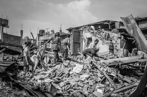 People on Debris of a House