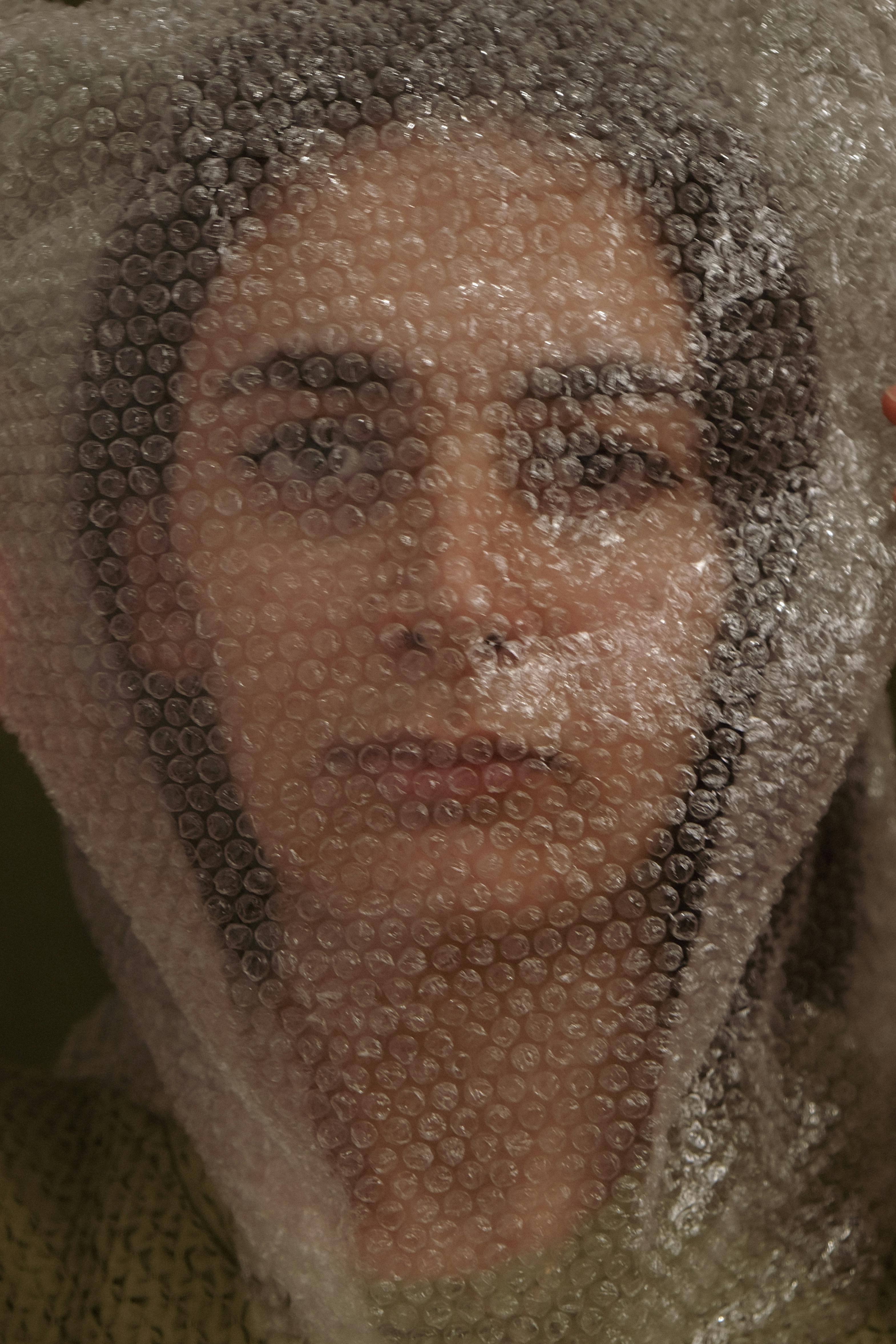 Woman Face behind Bubble Wrap · Free Stock Photo