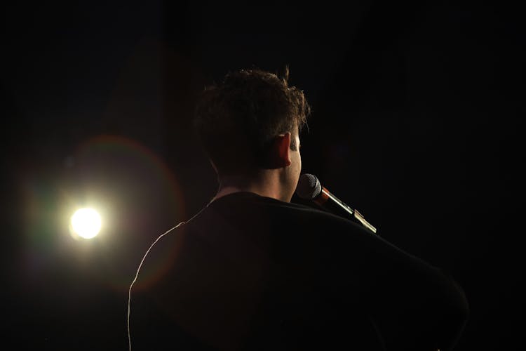 Back View Of A Singer In The Spotlight