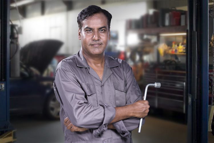 A Mechanic Holding A Tire Wrench