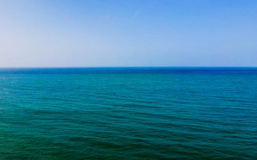 Free Picturesque turquoise sea with small waves under cloudless blue sky in sunny day Stock Photo