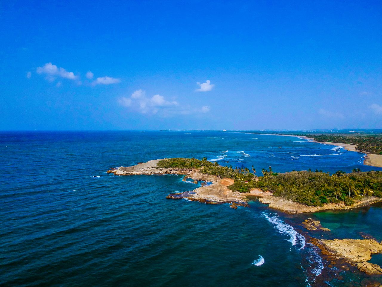 stunning aerial shot of a lush tropical coastline with vibrant blue wa