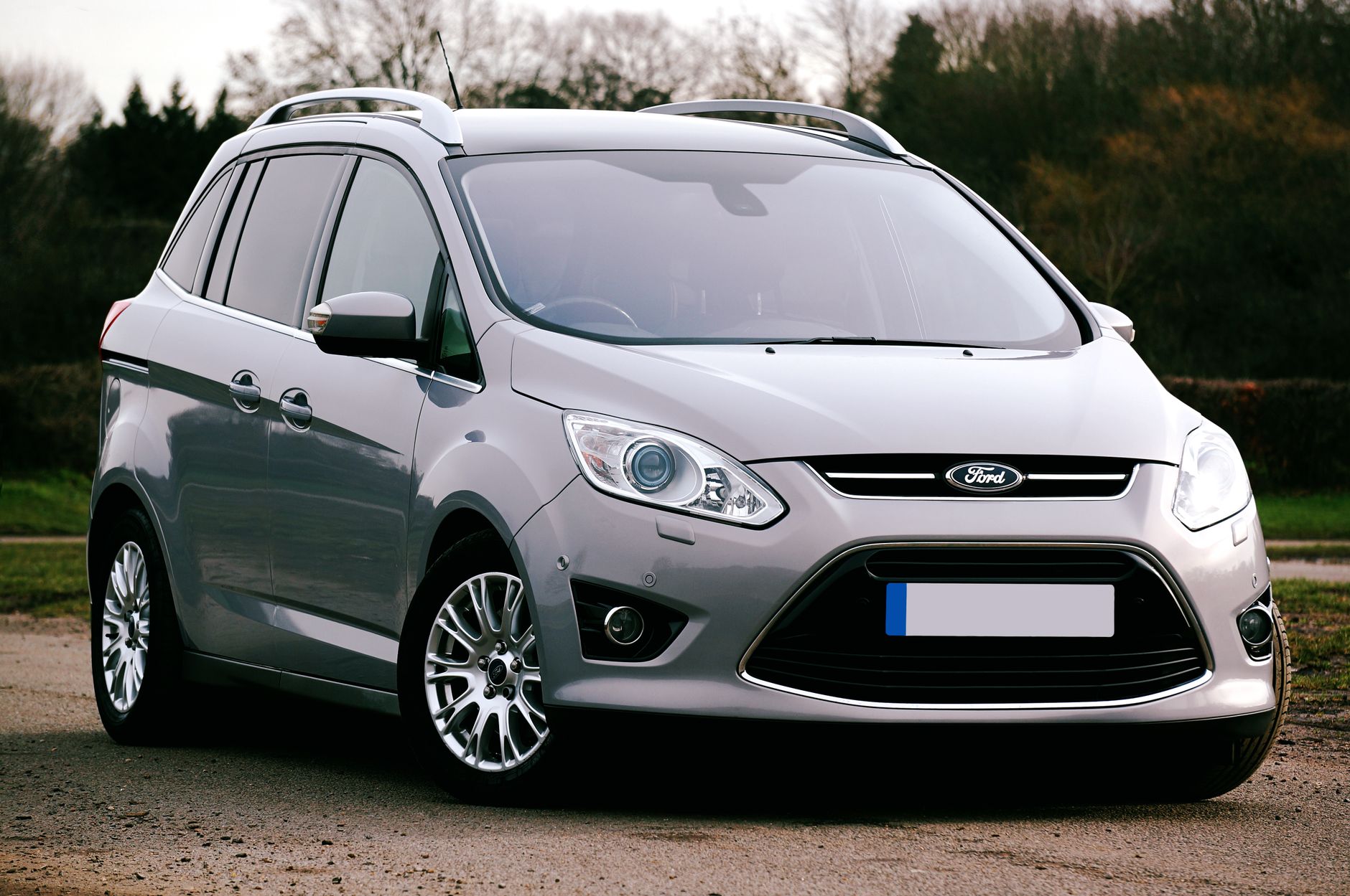 Silver Ford C-Max SUV parked on a road in the UK. Ideal for automotive themes.
