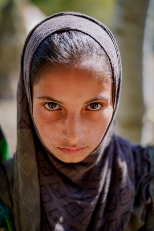 Free Close-up of a young woman wearing a hijab, natural light emphasis. Stock Photo