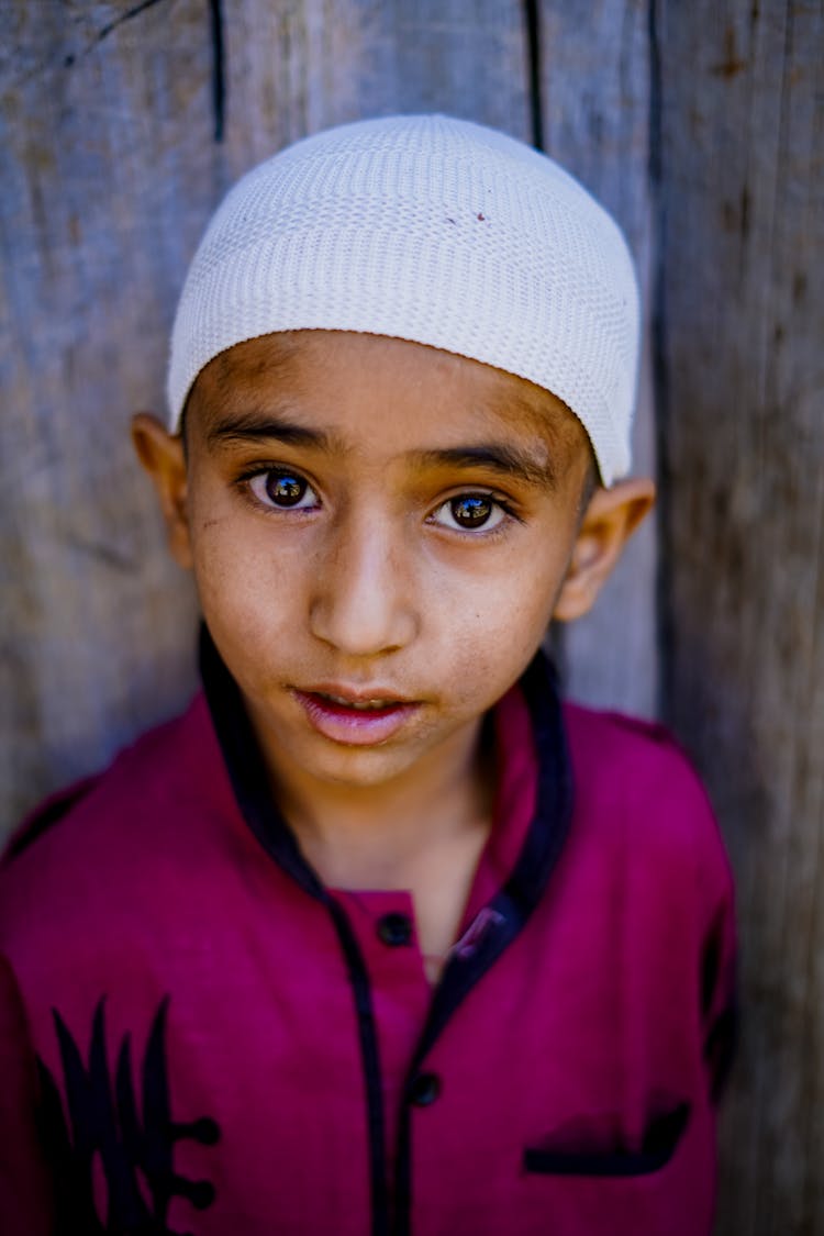 A Boy Wearing A White Beanie