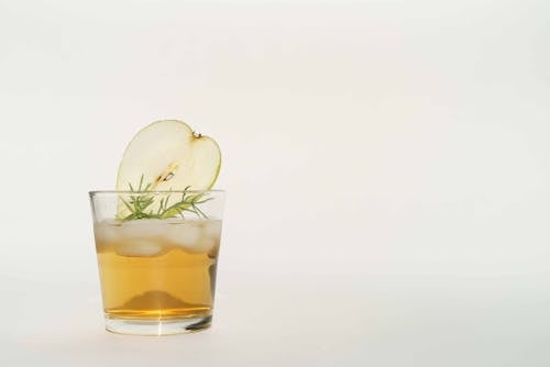 Glass of Rum on White Background