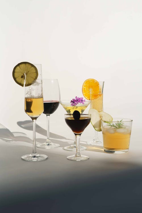 Cocktails with lemon and orange in glasses